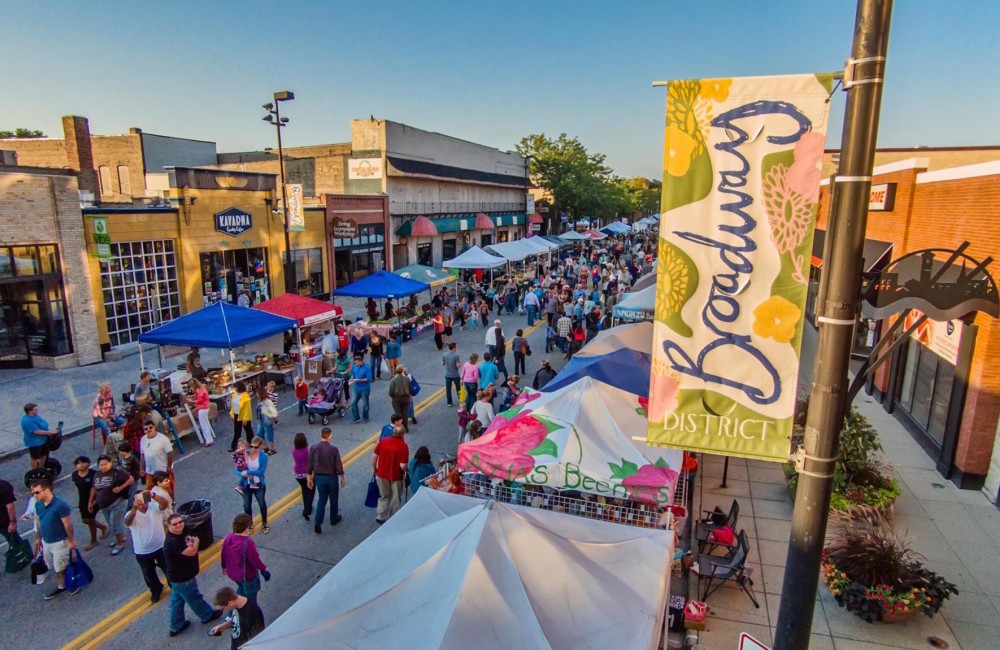Aerial shot of downtown street filled with pedestrians and booths.