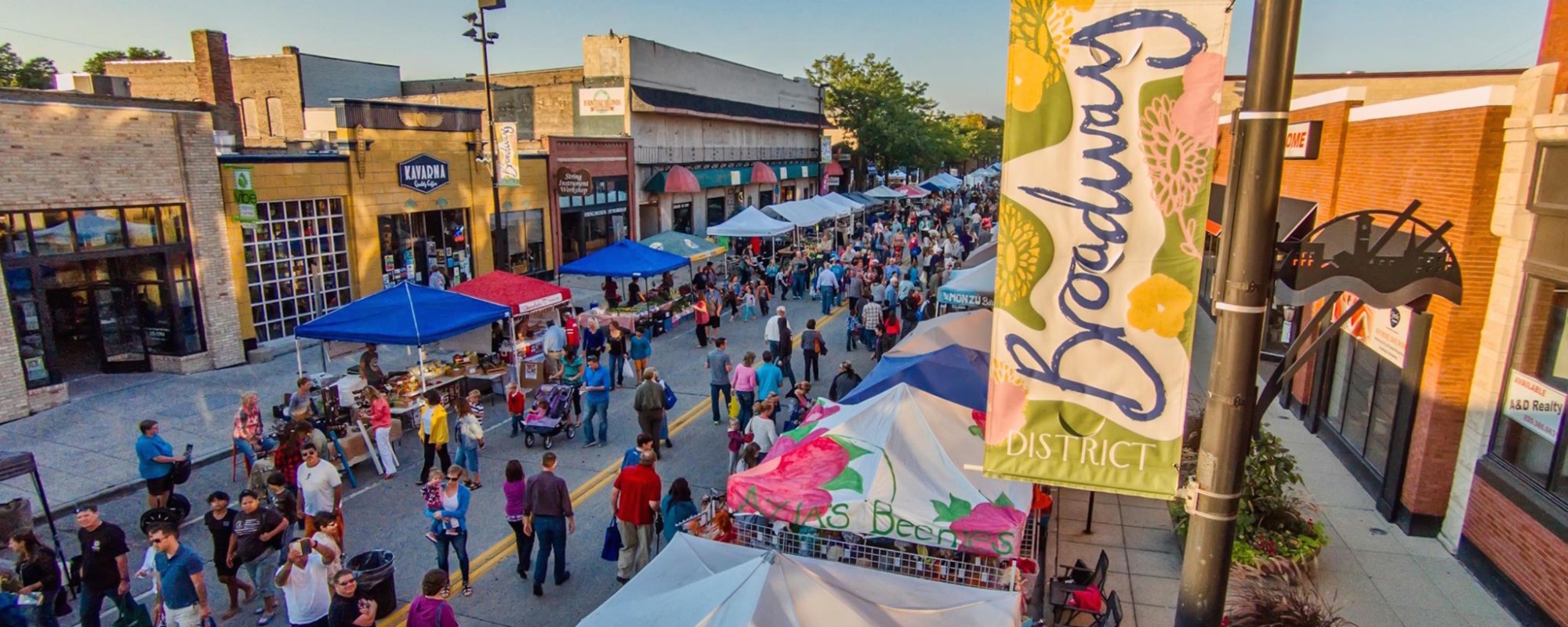 Aerial shot of downtown street filled with pedestrians and booths.