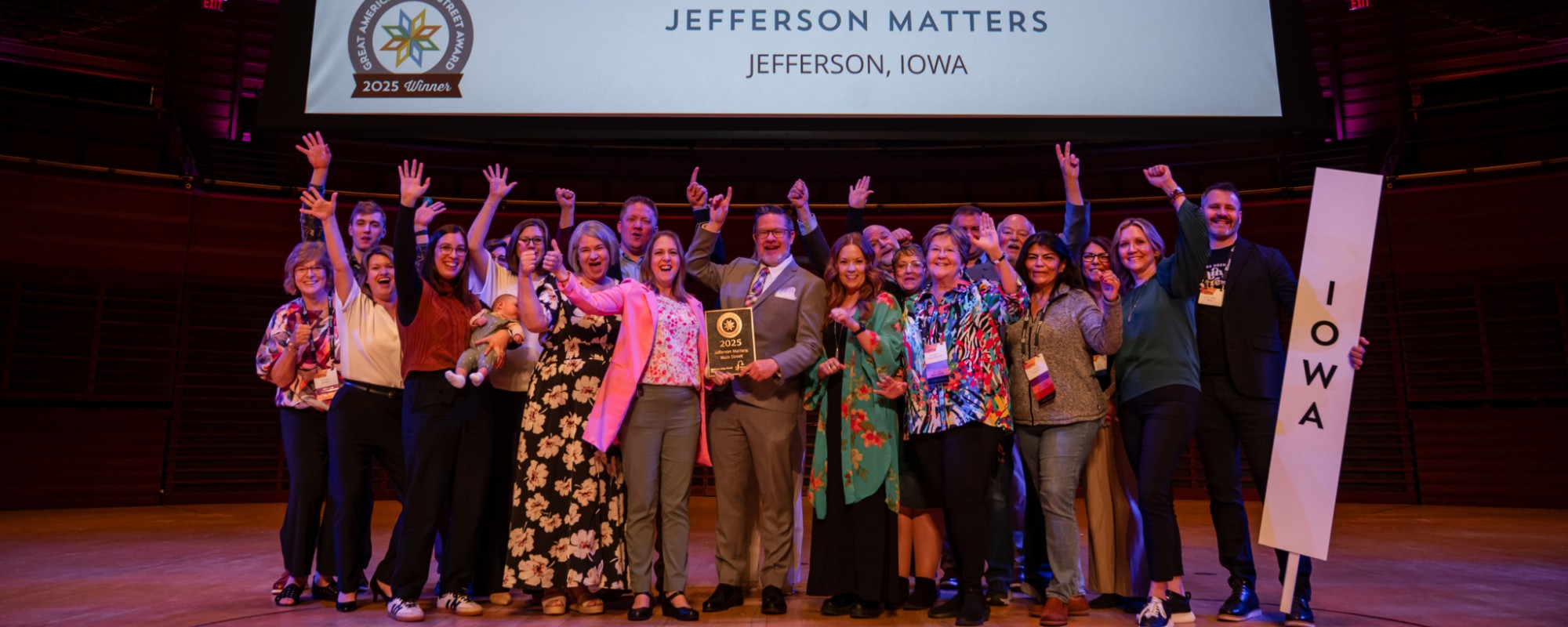 Jefferson Matters team holding their 2025 GAMSA plaque while posing for a celebratory photo, with the 2026 GAMSA visible in the lower right corner.