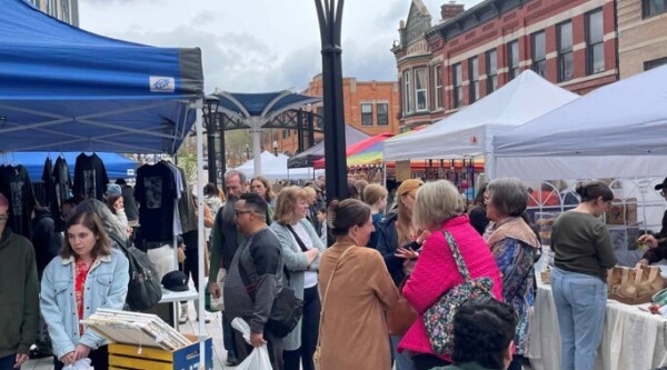 People browsing items at an outdoor market