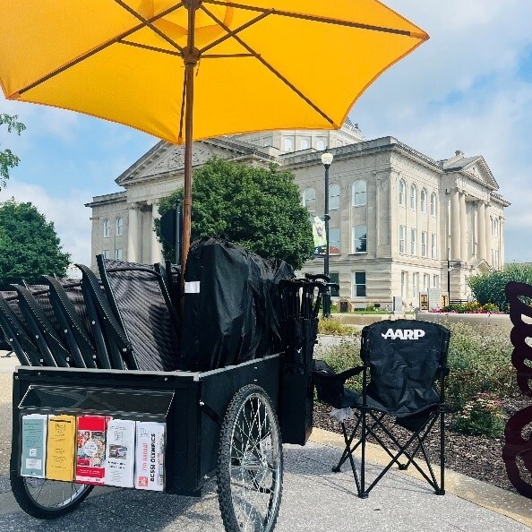 A cart carrying chairs and umbrellas for people to borrow