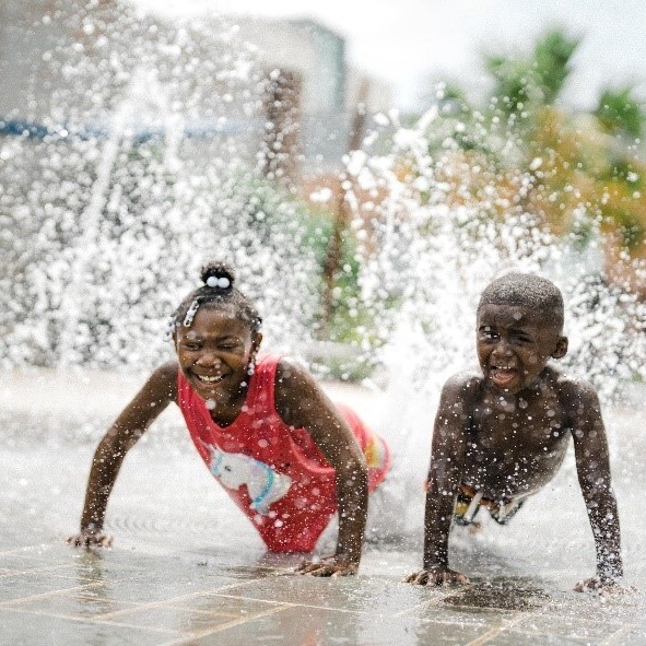 Two children playing in a splash pad