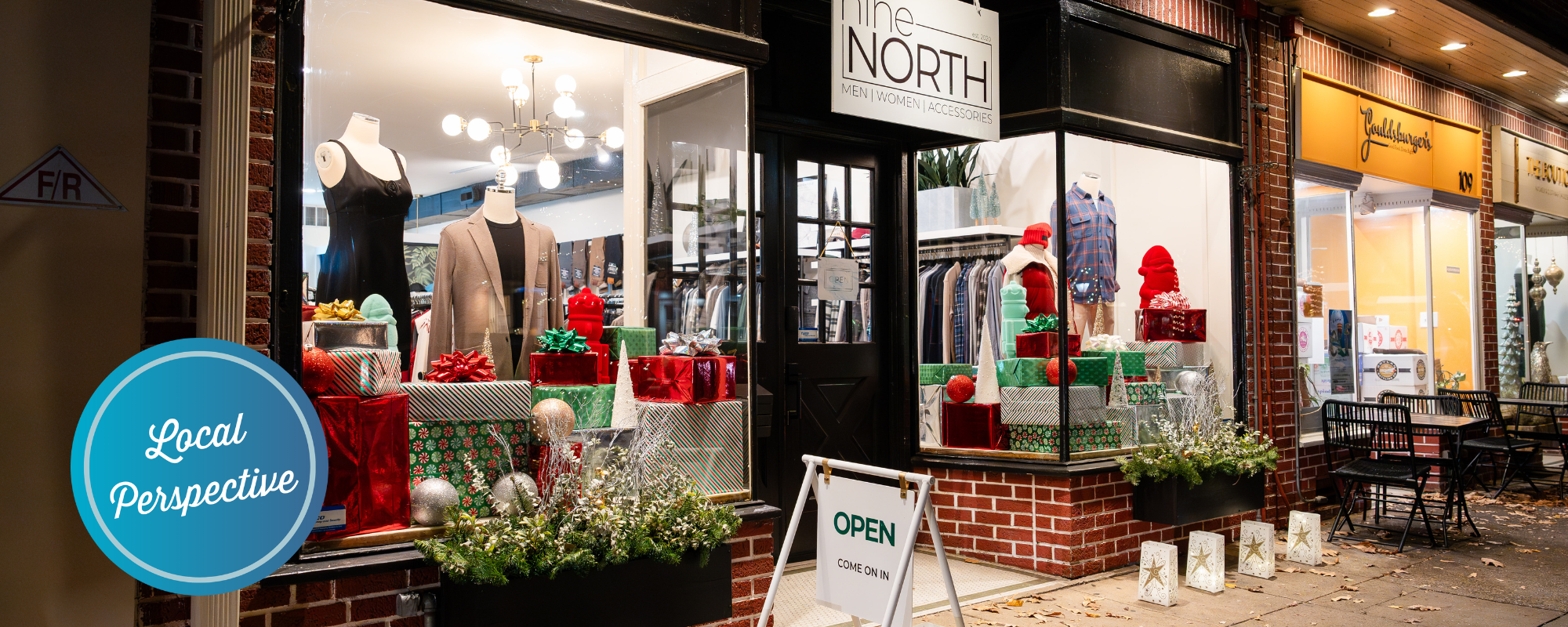 A downtown storefront with holiday decorations in the windows