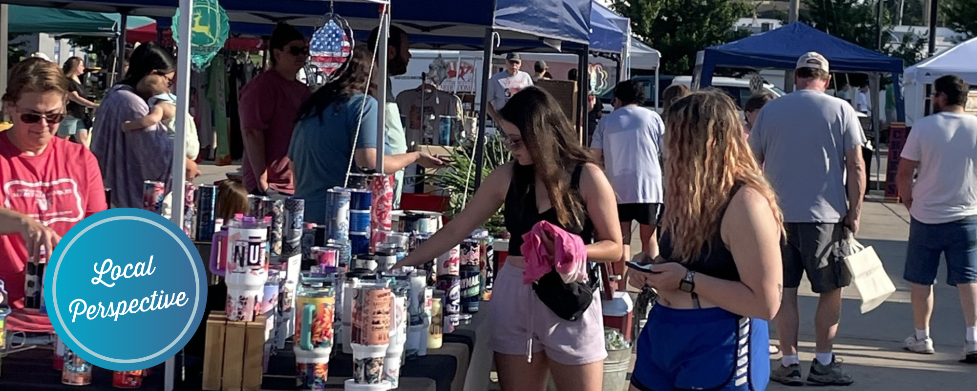 People shopping at stalls during a farmers' market