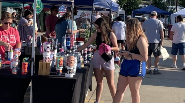 People shopping at stalls during a farmers' market