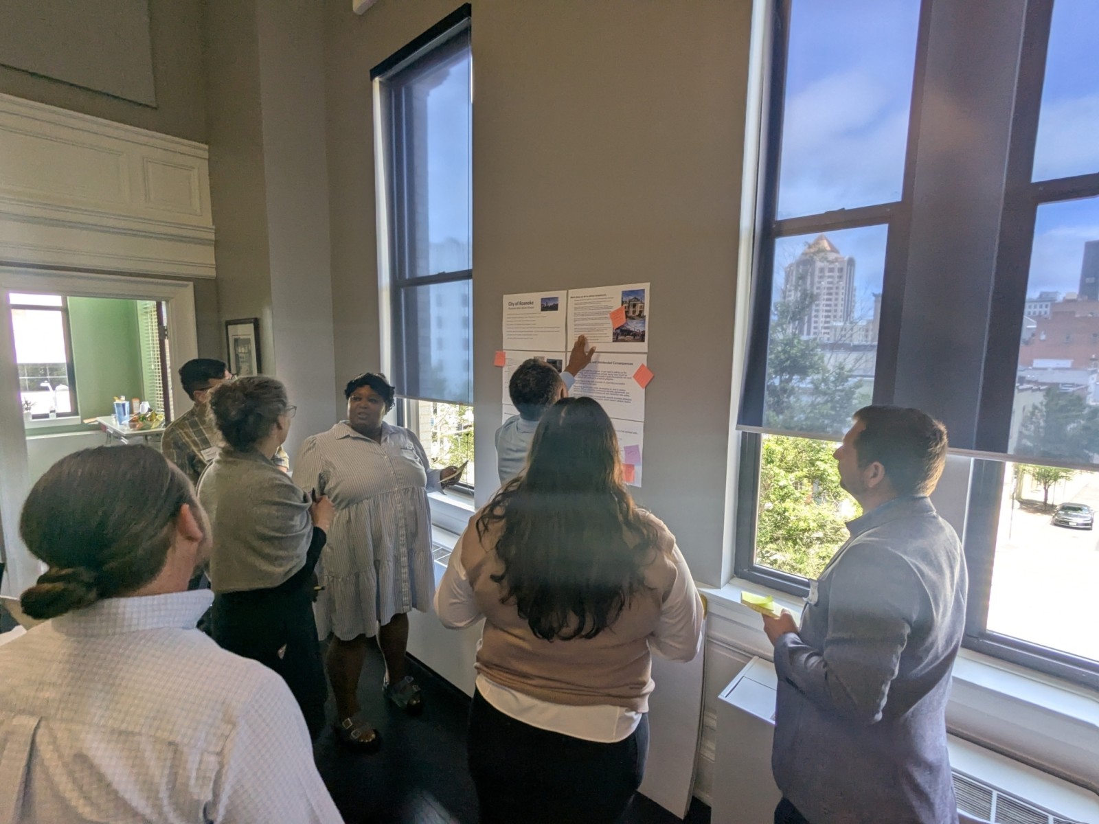 Participants write ideas on a large paper taped up on the wall