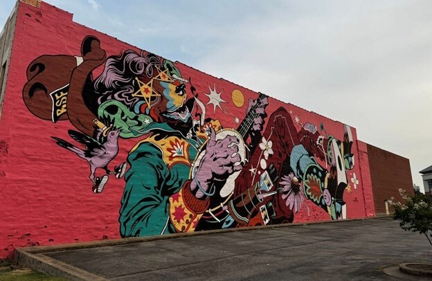 A colorful mural showing a man playing the banjo