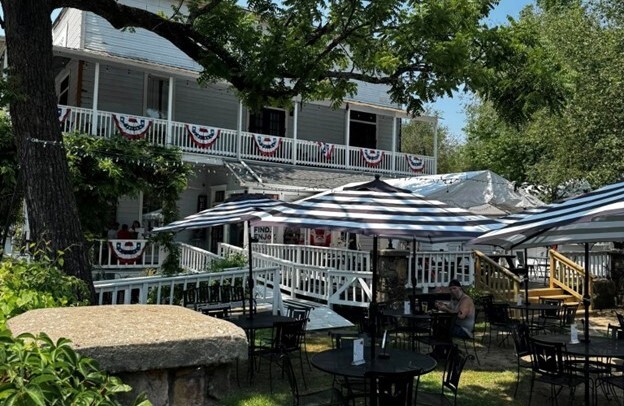 Tables set up on the sunny lawn of a historic building