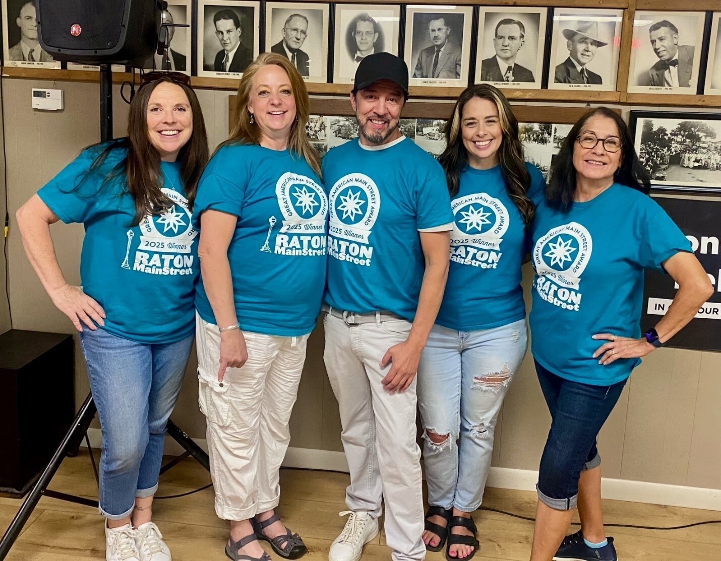 A group of people wearing t-shirts celebrating Raton MainStreet's GAMSA win.