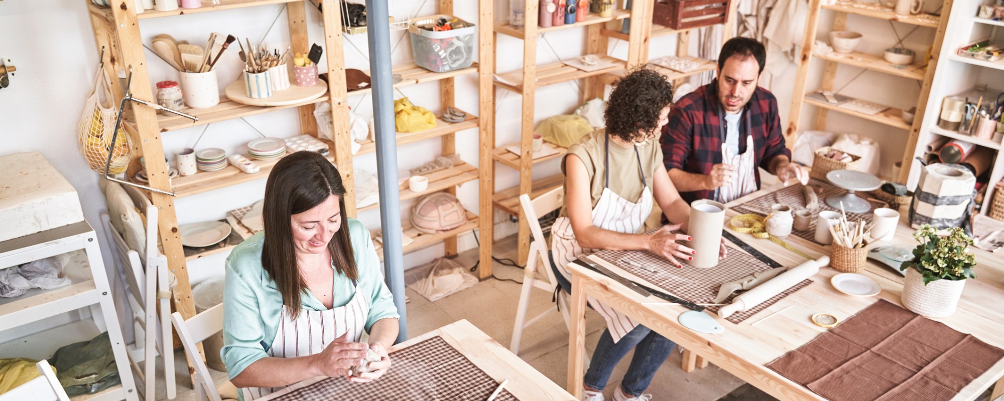 People making pottery during a class in a store