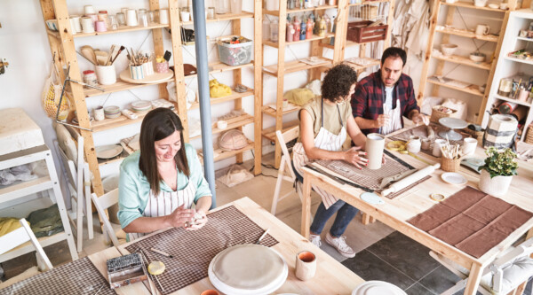 People making pottery during a class in a store