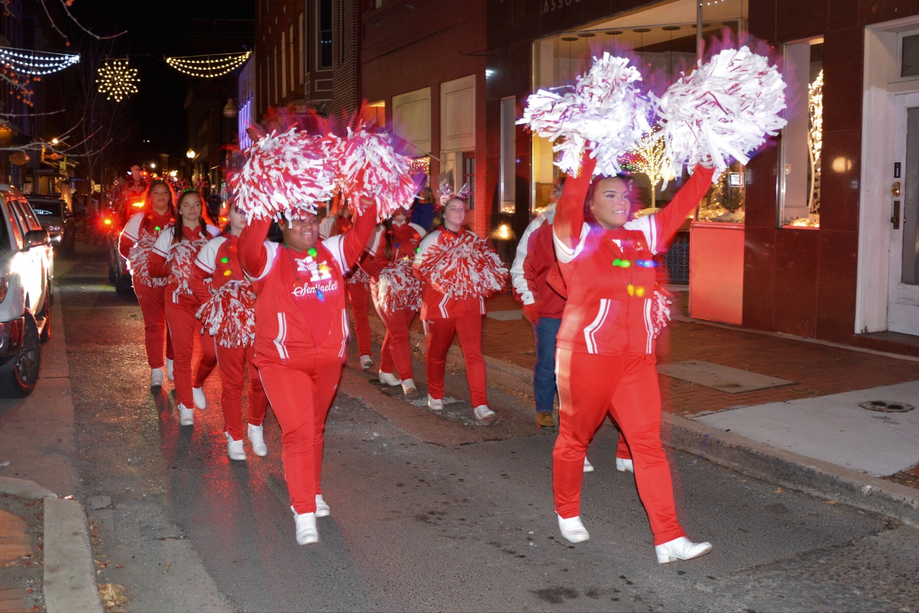 Cheerleaders marching in a downtown parade