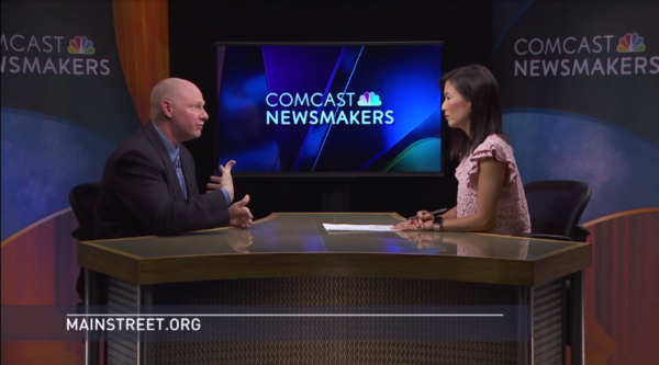 Man and woman have discussion on news show.