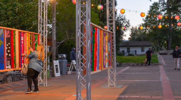 A woman looks at a downtown art installation