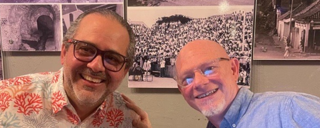 Two men smiling at camera