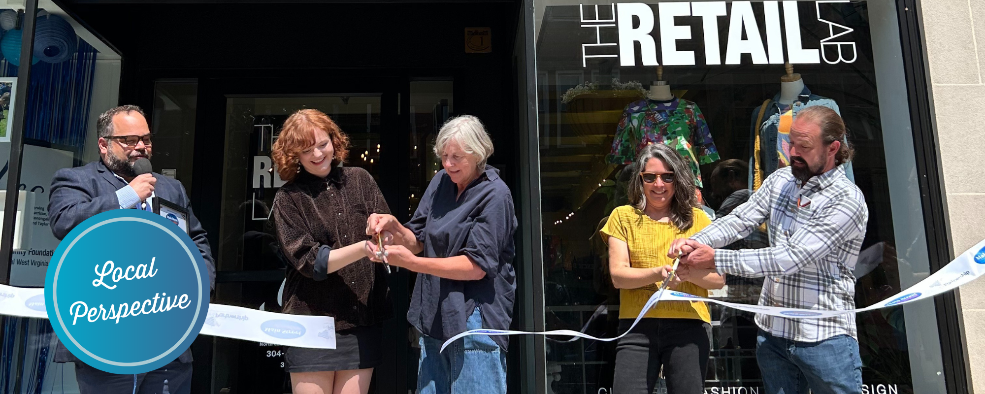 People participating in a ribbon cutting at The Retail Lab