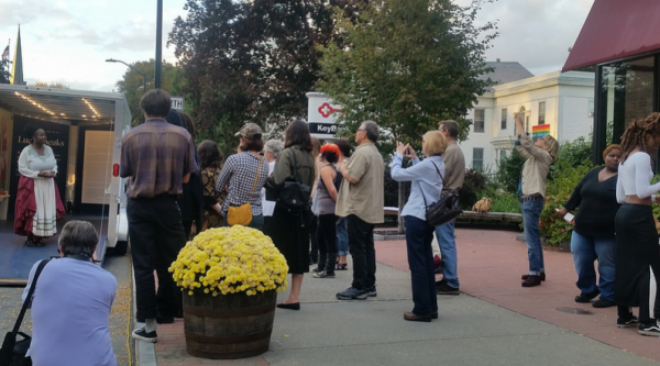 Group of people gathering around a mobile mini-museum