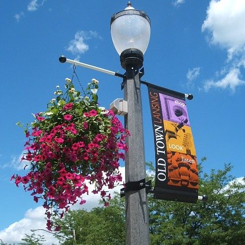 Banner and flowers hanging on lamp post